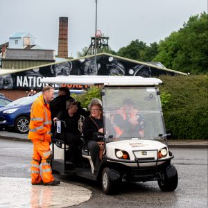 A group of people on the Shuttle Bus, speaking to a Mine Guide