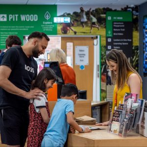 A family group paying for items in the Museum's shop